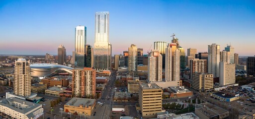 Edmonton skyline at twilight. Modern high-rises and construction cranes dominate the urban landscape. City life in action., Edmonton, Alberta, Canada