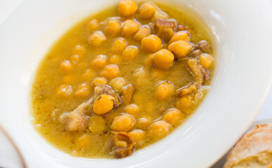 Tasty stew of garbanzos with iberian ham served with bread