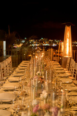 Tables set for an event party or wedding reception. Elegant table setting dinner in a restaurant. Glasses and dishes.