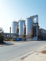 Obraz premium Large oil storage tanks located in an industrial area under a clear blue sky during daylight hours. Generative AI