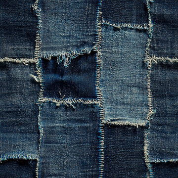 Frayed denim patchwork texture with varying shades of blue fabric pieces
