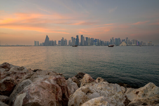 doha qatar skyscrapers by the sea at sunset