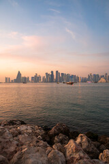 doha qatar skyscrapers by the sea at sunset