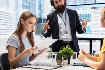 Financial advisor in office guiding people in trading shares online on forex market. Consultant offers investors tips on buying, selling and holding stocks to gain money and increase wealth
