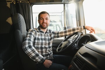 Side view of professional driver behind the wheel in truck's cabin