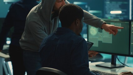 Cyber security team conducting cyber surveillance and threat detection in a governmental agency. Hackers working on cybercrime and malware prevention, data breach protection. Camera A.