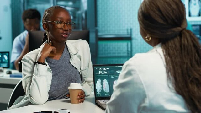 African american girl with bronchitis and a sore throat discuss with medic at the facility, uncomfortable laryngitis inflammation. Physician treating an unhealthy patient with pain. Camera A.