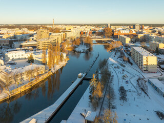 Snow-covered Brda River embankment with the lock and the Władysław Jagiełło Bridge on a frosty...