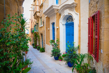 Cozy street and traditional colorful wooden balconies in Birgu, Malta © Olena Zn
