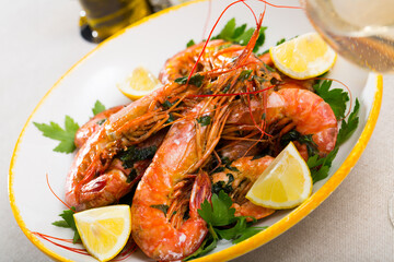 Appetizing fried shrimps with lemon and parsley. High quality photo