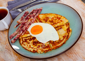 Delicious pancakes with scrambled eggs and bacon. Healthy breakfast