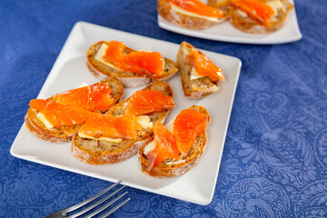 Tasty sandwich with raw salmon slices and cream butter