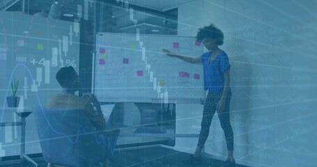 Image of financial data processing over diverse colleagues discussing work in office