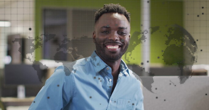 Image of globe and digital data processing over african american businessman in office