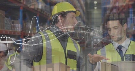 Image of diagrams over caucasian male workers talking in warehouse