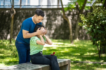 Young man about to surprise his girlfriend with a marriage proposal