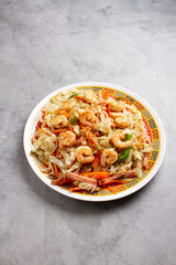 shop sue, with fried rice and shrimp on a marble background