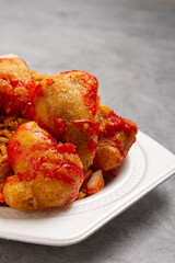 Chinese food of sweet and sour chicken with fried rice, on marble background