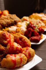 dish of sweet and sour chicken, Chinese rice and Chinese style fried chicken on brown table