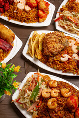 a table with chinese food,  chinese rice, Chinese pork ribs with broaster chicken, fried rice, spring roll, shrimp, French fries on white plates