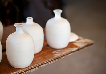 Handmade ceramic vases and dishes on display in a shop,  retail craft market