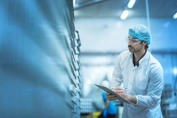 Worker in a clean production environment conducting inspections Highlights of quality assurance...