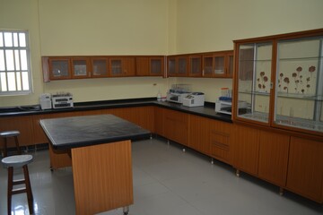 Obraz premium Spacious and Modern Laboratory Interior Featuring Wooden Cabinets, Clean Workspaces, and Scientific Equipment Ideal for Research and Experiments