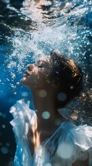 A serene young woman submerged in water, exuding tranquility and grace.