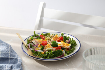 Salad with tuna on a light table.
