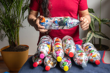 Recycling and sustainability. Plastic bottles filled with packaging. Bottles of love'. Botellas de amor. Ecological bricks. Ecoladrillos