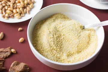 Yellow garri in a white bowl, top view of nigerian garri in a ceramic bowl, fried cassava, garri for eba