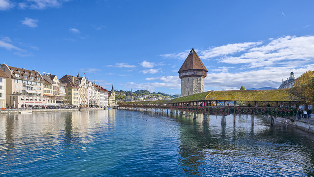 Luzern, Switzerland - October 22, 2023: High angle and morning view of Kapellbr?cke with tourists on Lake Lucerne against houses of old town