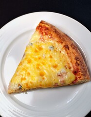 A cheesy slice of pizza on a white plate.