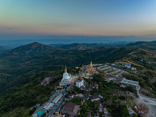 Aerial view amazing Big White Five buddha Statues in sunset. beautiful golden pavilion of Wat Phachonkeaw decorate with jewels and stones on the hill very beautiful and famous landmark in Thailand.