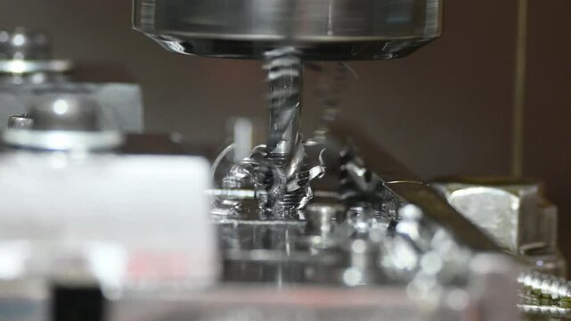 Zoom out scene the thread making process by tapping tool on CNC milling machine.