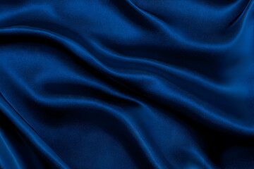 Obraz premium Smooth, elegant blue silk fabric drapes gracefully, forming gentle folds and ripples across the surface.