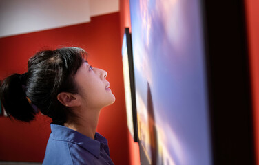 Fototapeta premium Woman watching art pictures in exhibition