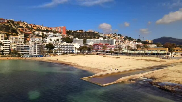 Experience the stunning landscape of Santa Ponsa beach in Mallorca. The clear waters, sandy shores, and surrounding hills provide a perfect backdrop for relaxation and outdoor activities.