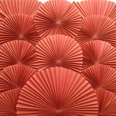 Coral Paper Fans Arranged in an Overlapping Circular Pattern Creates a Textured Background