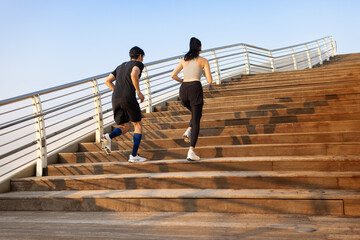 Young couple running on the steps