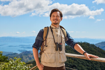 Happy man hiking in the mountains