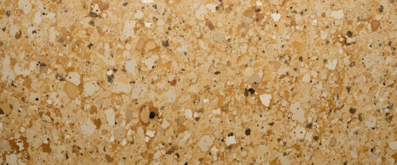 A textured surface featuring a blend of beige and brown particles.