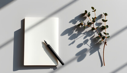 Minimalist Workspace with Notebook, Pen, and Plant on Gray Background