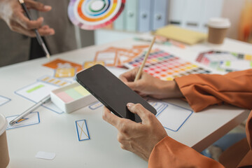 UI UX designers team working on new website wireframe in office, ux developer and ui designer use...