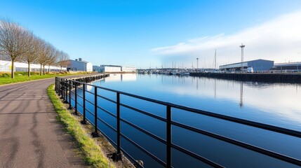 Fototapeta premium Calm harbor, path, boats, clear sky, industrial background, perfect for travel or real estate