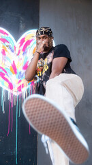 Male model in front of a graffiti heart