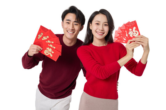 Cheerful young couple holding red envelopes
