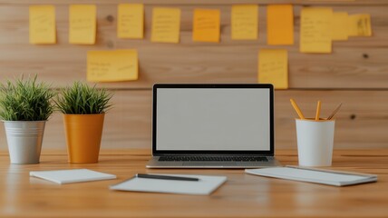 A modern workspace featuring a laptop, stationery, and plants, with sticky notes on a wooden wall, creating an organized and productive atmosphere.