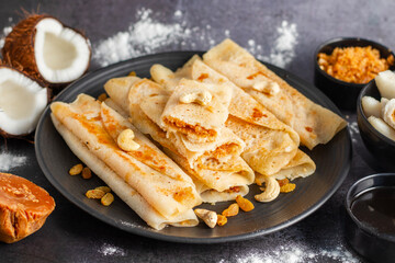 Pitha Pulli is a traditional Bengali sweet made with rice flour, jaggery, coconut, and spices, often steamed or fried.