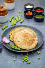 Matar paratha is a delicious Indian flatbread stuffed with spiced mashed green peas, cooked until golden and served with chutney.
